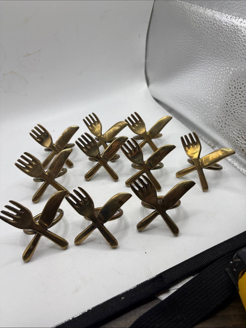 Set of 10 brass napkin rings.Fork and Knife